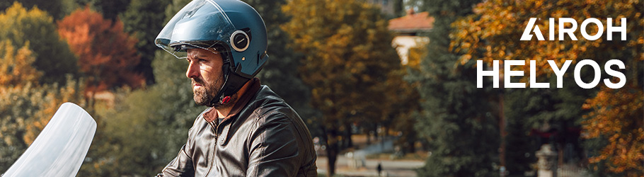 Airoh Helme - Mann auf Motorrad vor urbaner Gegend mit Airoh Helyos Helm